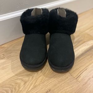 Woman’s black UGG boots